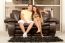 Young Couple Sitting On Sofa