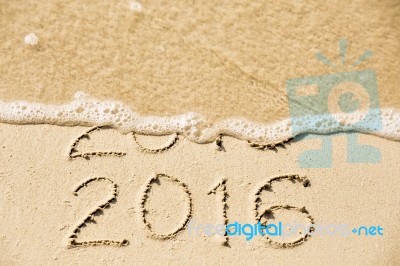 2015 2016 Inscription Written In The Wet Yellow Beach Sand Being… Stock Photo