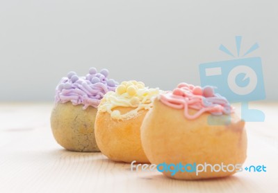 3 Color Choux Or Profiterole Or Eclair On Wood Table Oblique View Stock Photo