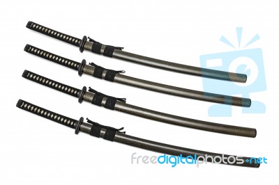 4 Japanese Swords And Green Textured Scabbard With Black Cord Isolated In White Background Stock Photo