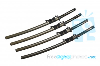 4 Japanese Swords And Green Textured Scabbard With Black Cord Isolated In White Background Stock Photo