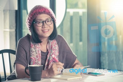 40s Years Old Asian Woman Relaxing Reading And Drinking Coffee In Coffee Shop With Smiling Face Happiness Emotion Stock Photo