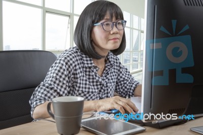 45s Years Woman Working In Front Of Computer Monitor Office Life Theme Stock Photo