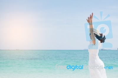 A Beautiful Carefree Woman Relaxing At The Beach Enjoying Her Su… Stock Photo