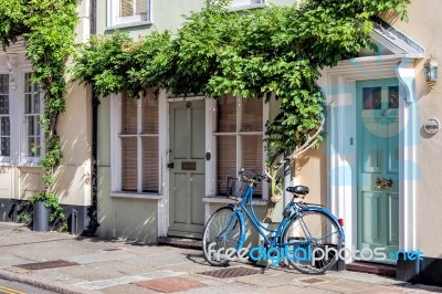 A Blue Bicycle Leaning Against A House In Sandwich Kent Stock Photo