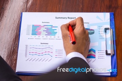 A Business Man Is Using A Pen To Write On The Paper Reported Stock Photo