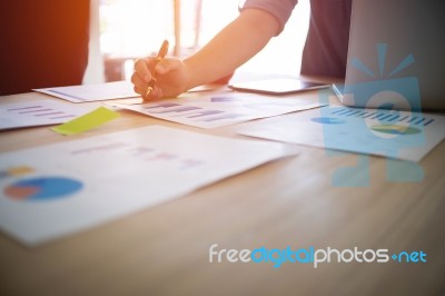 A Business Man Working On Wooden Desk(table) With Laptop And Pen… Stock Photo