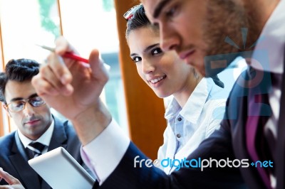 A Business Team Of Three Sitting In Office And Planning Work Stock Photo