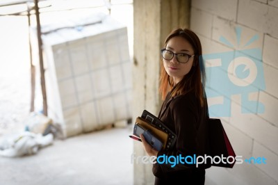 A Businesswoman Holds A Calculator While Walking Down A Stairwel… Stock Photo