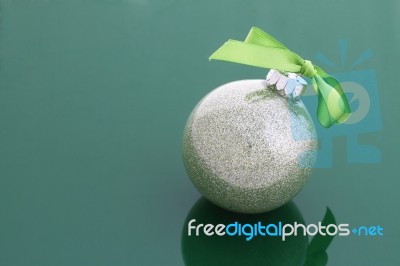 A Christmas Ball With Green Ribbon Stock Photo