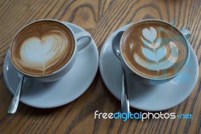 A Cup Of Coffee With Heart Pattern In A White Cup Stock Photo