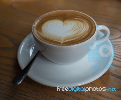 A Cup Of Coffee With Heart Pattern In A White Cup Stock Photo