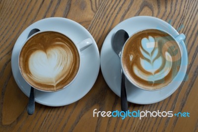 A Cup Of Coffee With Heart Pattern In A White Cup Stock Photo