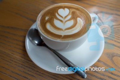 A Cup Of Coffee With Heart Pattern In A White Cup Stock Photo