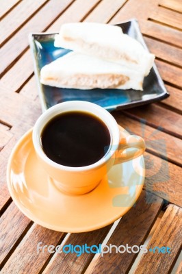 A Cup Of Hot Coffee With Sandwiches Stock Photo