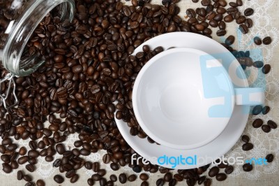 A Empty Cup Of Coffee And Beans Stock Photo