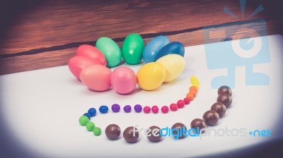 A Few Colorful Easter Eggs As A Flower Shape With Candies And Chocolate Over Wood Background Right Side View Happy Easter Stock Photo