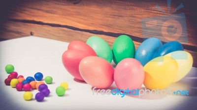 A Few Colorful Easter Eggs As A Flower Shape With Candies Over Wood Background Close Up Happy Easter Stock Photo