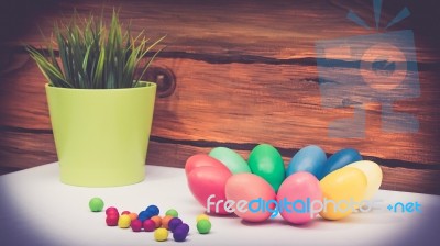 A Few Colorful Easter Eggs As A Flower Shape With Candies Trail And Garden Plants Over Wood Background Left View Close Up Happy Easter Stock Photo