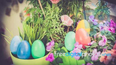 A Few Colorful Easter Eggs At The Green Garden With Colorful Flowers Happy Easter Stock Photo