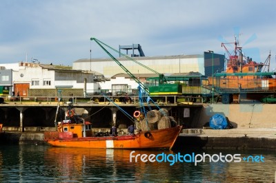 A Fishing Boat Moored In The Harbor Stock Photo