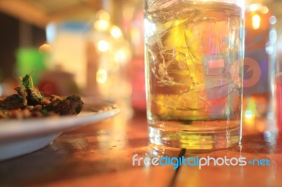 A Glass Of Whiskey And Some Food Stock Photo