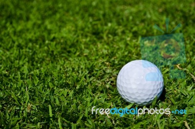 A Glof Ball On Green Field Stock Photo