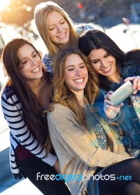 A Group Of Friends Taking Photos With A Smartphone Stock Photo