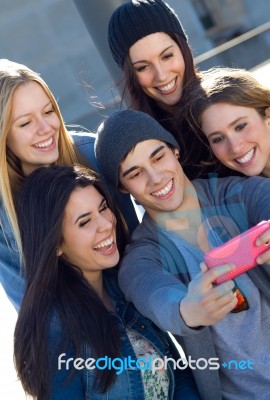 A Group Of Friends Taking Photos With A Smartphone Stock Photo