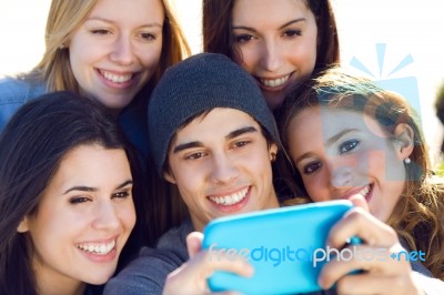 A Group Of Friends Taking Photos With A Smartphone Stock Photo