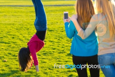 A Group Of Friends Taking Photos With A Smartphone Stock Photo