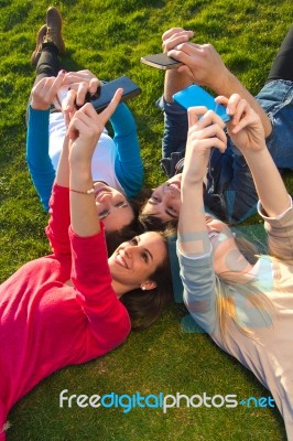 A Group Of Friends Taking Photos With A Smartphone Stock Photo