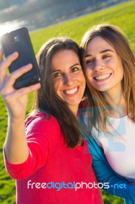 A Group Of Friends Taking Photos With A Smartphone Stock Photo