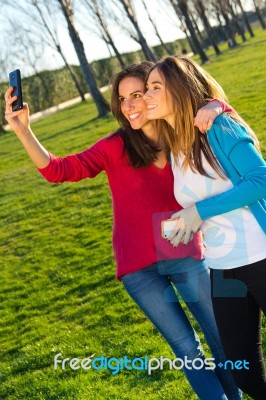 A Group Of Friends Taking Photos With A Smartphone Stock Photo