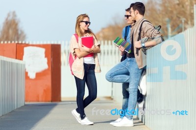 A Group Of Friends Talking In The Street After Class Stock Photo