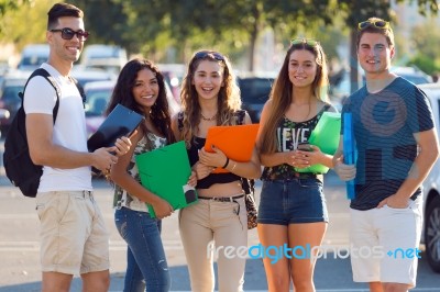 A Group Of Friends Talking In The Street After Class Stock Photo