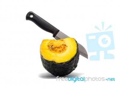 A Knife Stab Equal Part Pumpkin On White Background Stock Photo