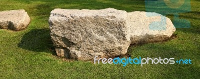 A Large Stone On Grass Stock Photo