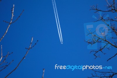 A Long Trail Of Jet Plane On Blue Sky Stock Photo