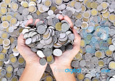 A Lot Of Coins In Hands Stock Photo