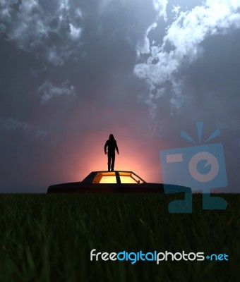 A Man Standing On The Roof Of The Car At Night Stock Image