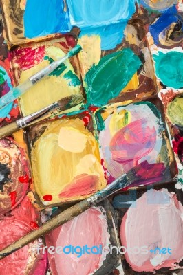 A Pallete With Three Brushes Stock Photo