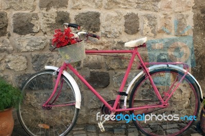 A Red And Pinky Bile In The Street ,n Front Of A Cafe Stock Photo