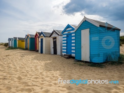 A Row Of Brightly Coloured Beach Huts In Southwold Stock Photo