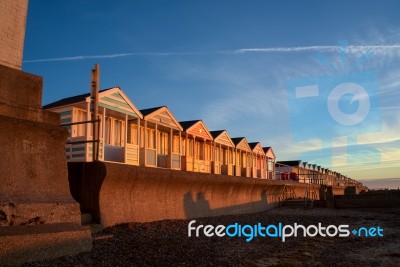 A Row Of Brightly Coloured Beach Huts In Southwold Stock Photo