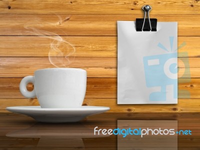 A White Cup Of Coffee And White Paper Stock Photo