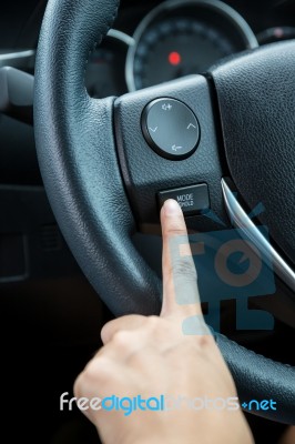 A Woman Hand Pushes The Mode Hold Control Button On A Steering Wheel Stock Photo