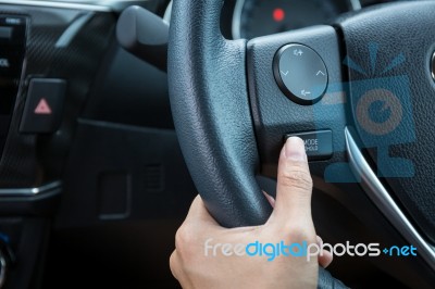 A Woman Hand Pushes The Mode Hold Control Button On A Steering Wheel Stock Photo