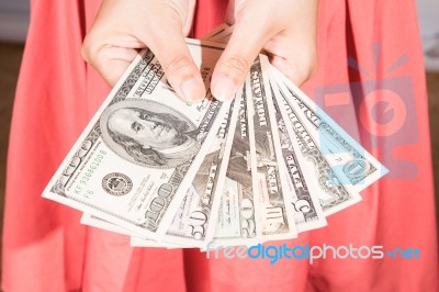 A Woman Hold Dollar Banknote In Hand Stock Photo