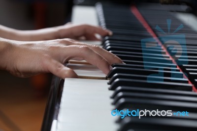 A Woman Playing Piano Stock Photo